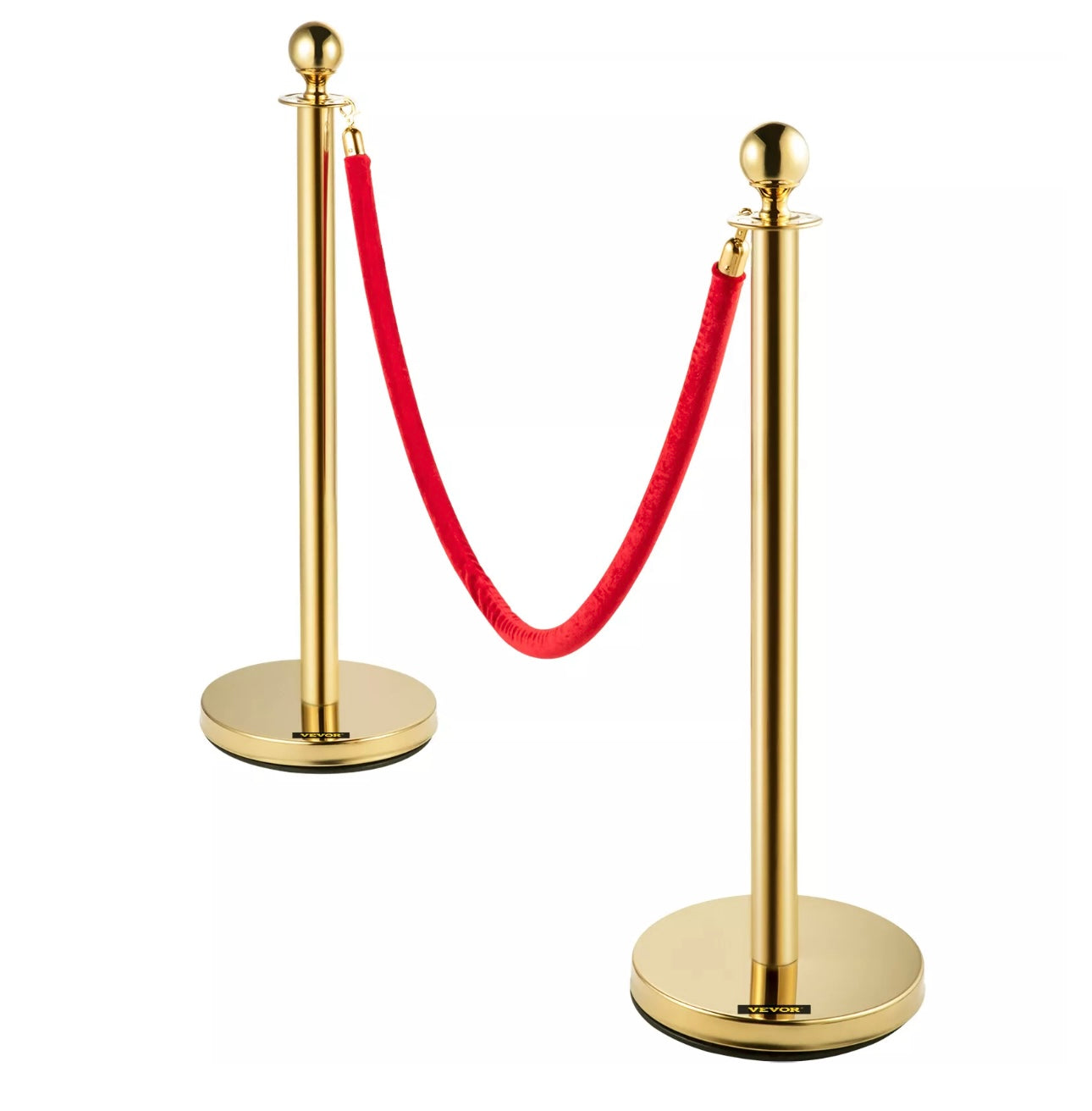 A set of gold-coloured stainless steel crowd control stanchions with red velvet ropes.