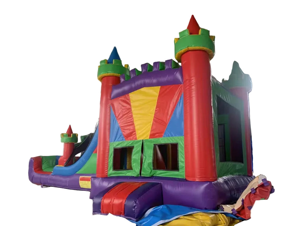 A large multicolored inflatable bouncy castle with two slides and a ball pit area, displayed indoors.