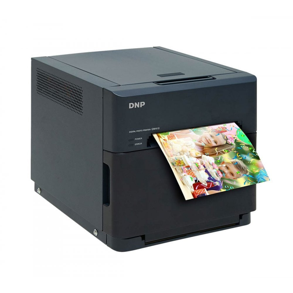 Black DNP photo printer with printed photos on a white background