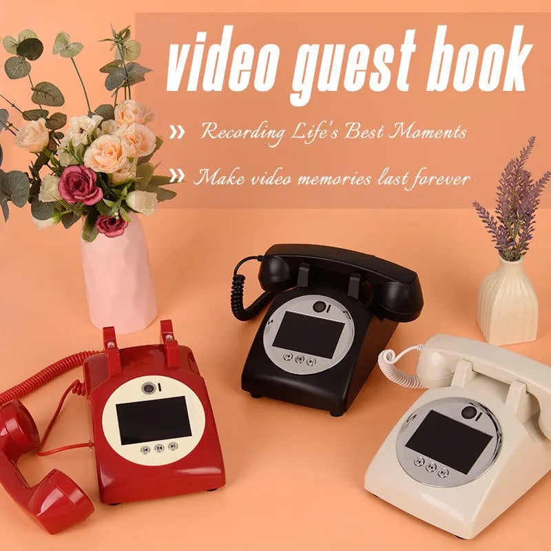 A vintage red telephone box styled as an audio guestbook with a neon sign that reads 'Oh hello', surrounded by decorations such as flowers and candle lanterns.