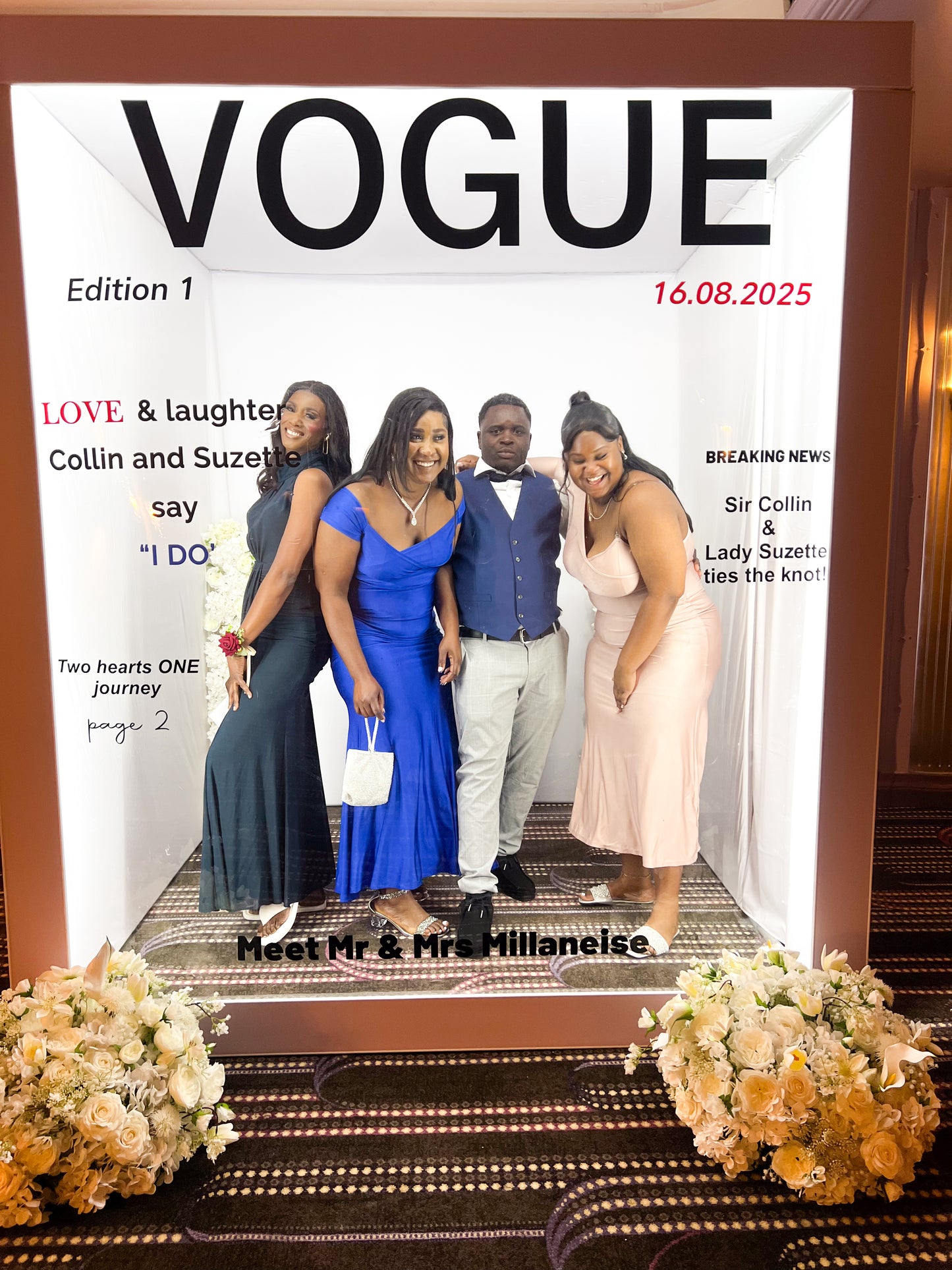 Vogue magazine photobooth with a group of people inside it, surrounded by flowers.