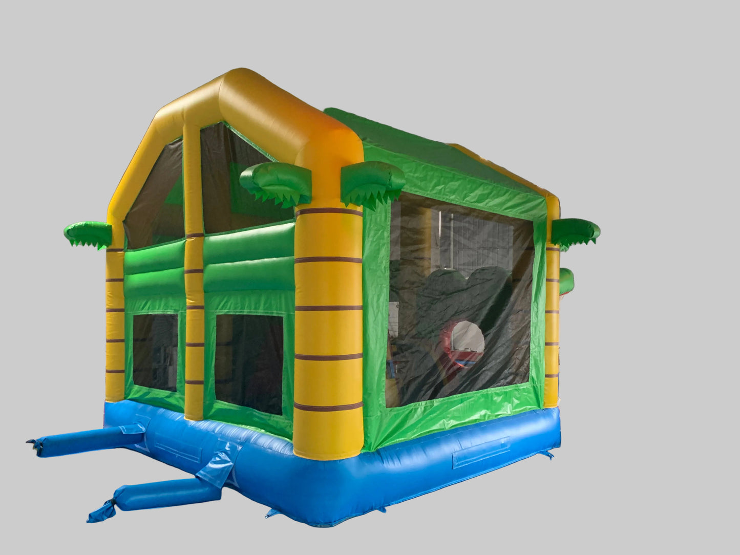 Inflatable bounce house with green, yellow, and blue colours
