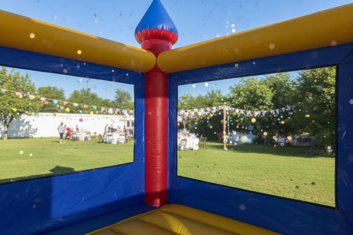 Inflatable bounce house with colorful roof in a warehouse setting
