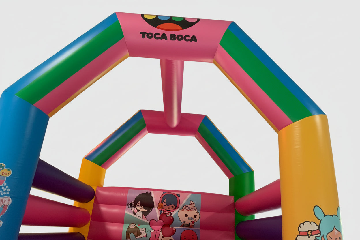 Colorful inflatable play bouncy house with Toca Boca branding on a white background