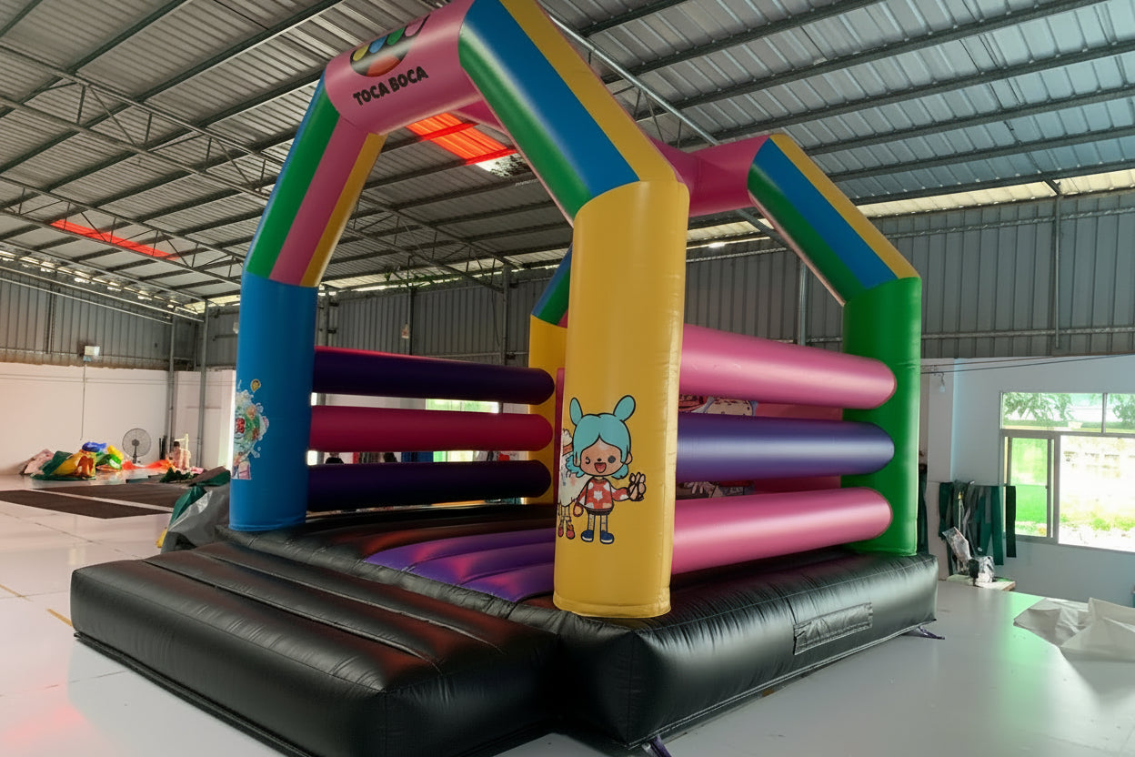 Colorful inflatable play structure with cartoon character in a warehouse setting