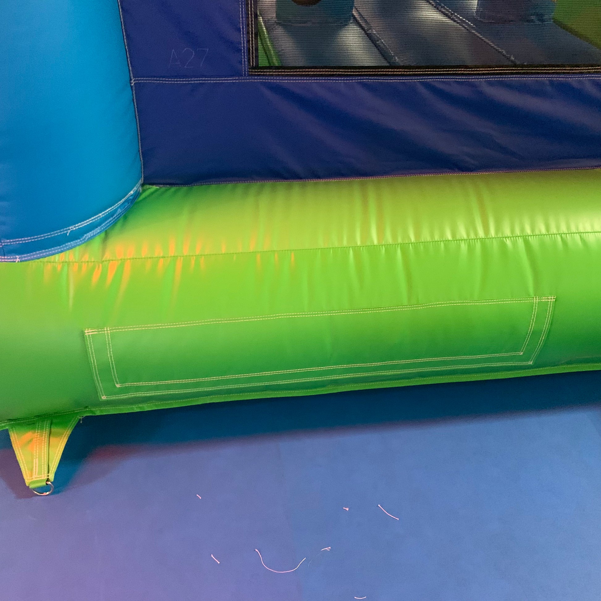 Green inflatable Mario bouncy house on a blue surface