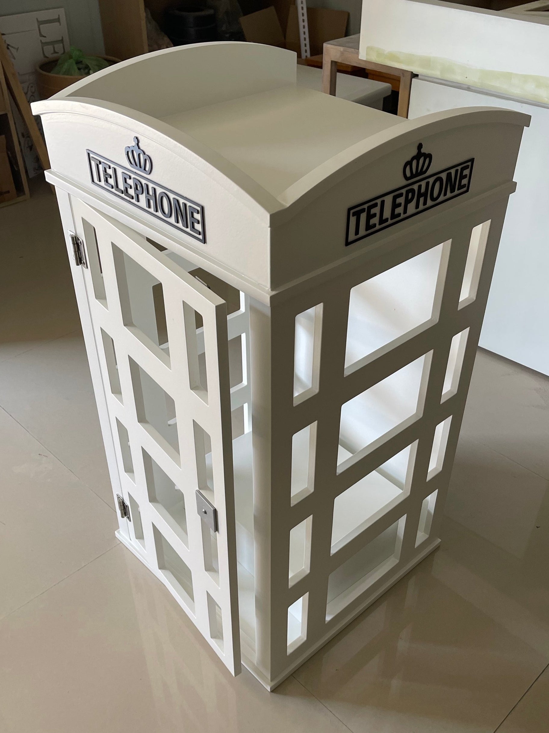 Model of a telephone booth on a tiled floor