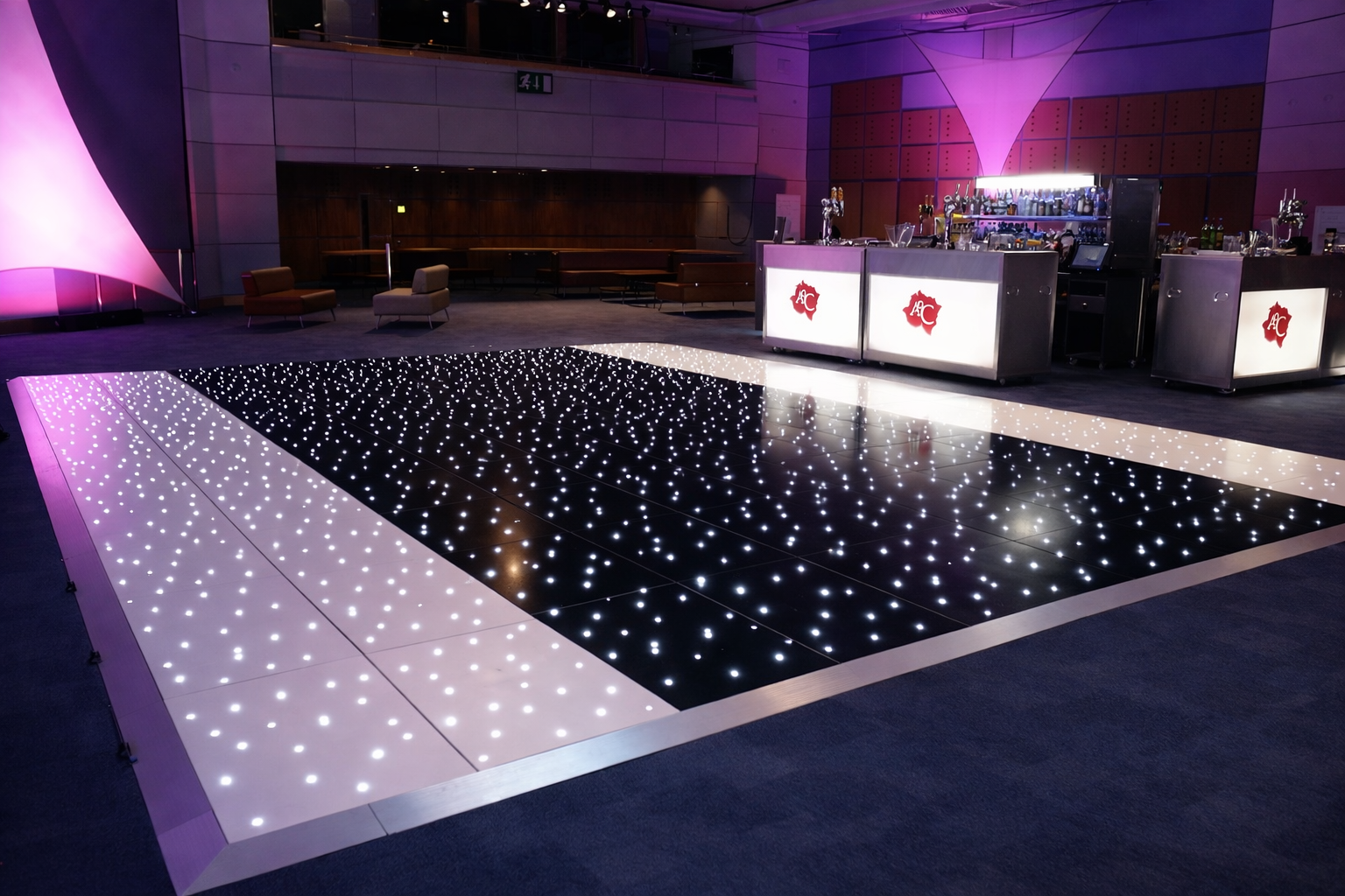  Black Starlit LED Dance Floor in a lit room with purple and pink lighting.