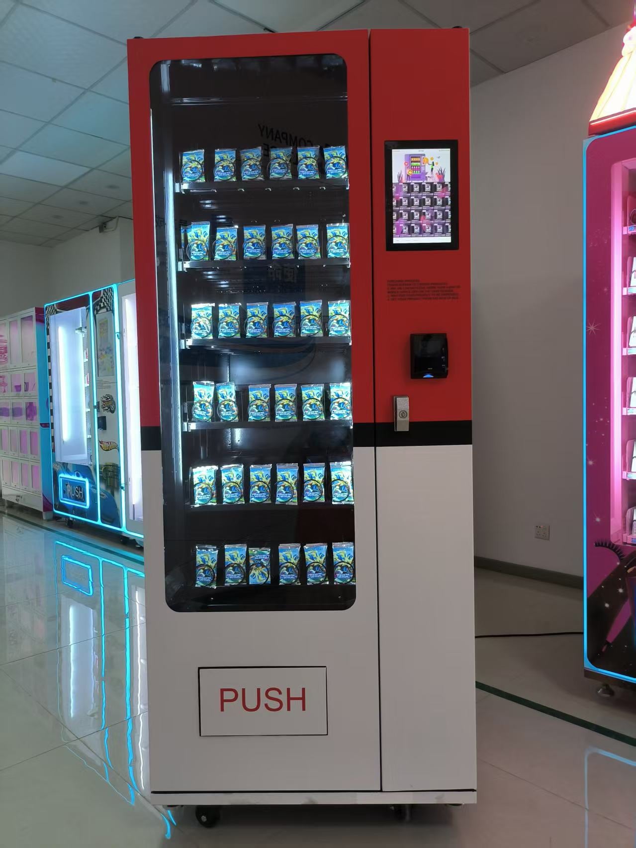 White and Red Vending machine with a push button on a reflective floor