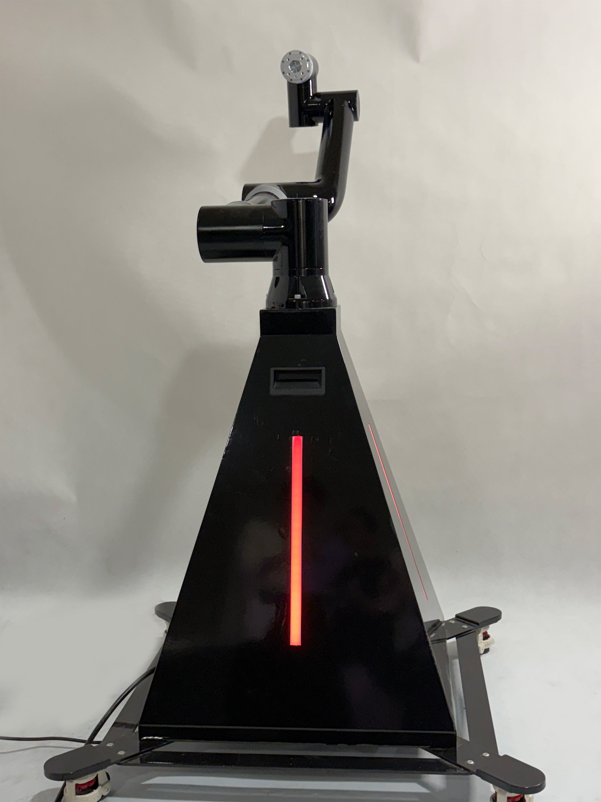 A black robotic arm photobooth with a colorful light stripe, designed for capturing images at events such as weddings and parties.