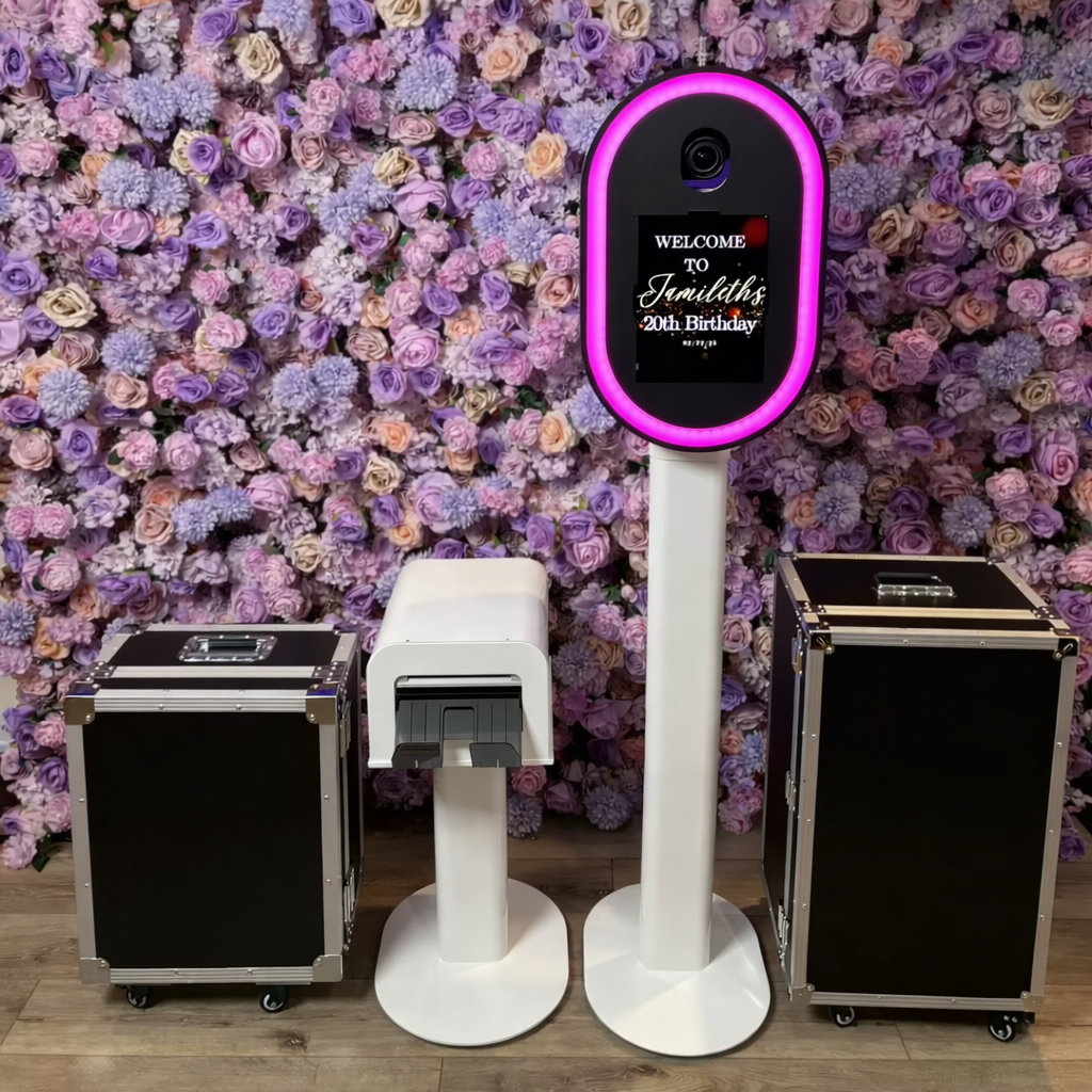 Photo booth setup with a floral backdrop, a printer stand and 2 flight cases