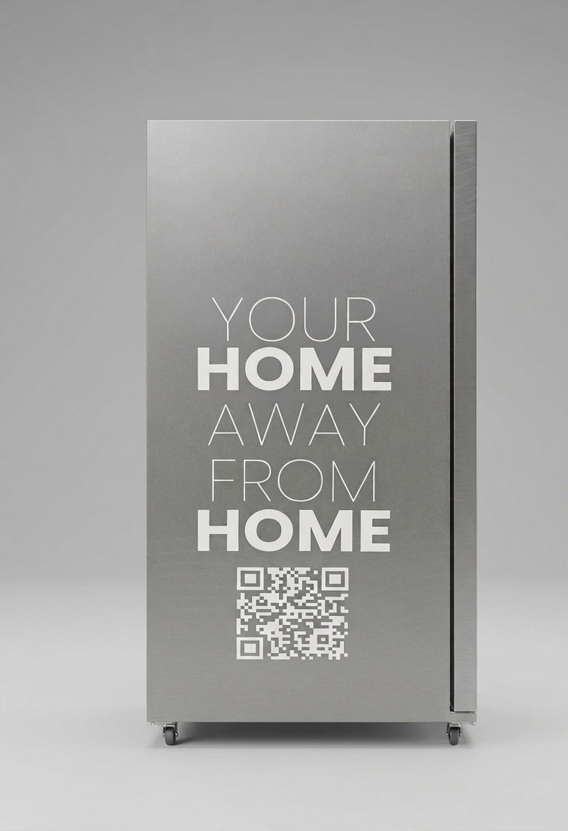 Metallic vending machine with 'Your Home Away From Home' text and QR code on a gray background