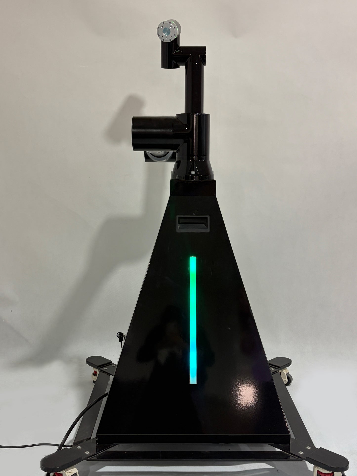A black robotic arm photobooth with a colorful light stripe, designed for capturing images at events such as weddings and parties.