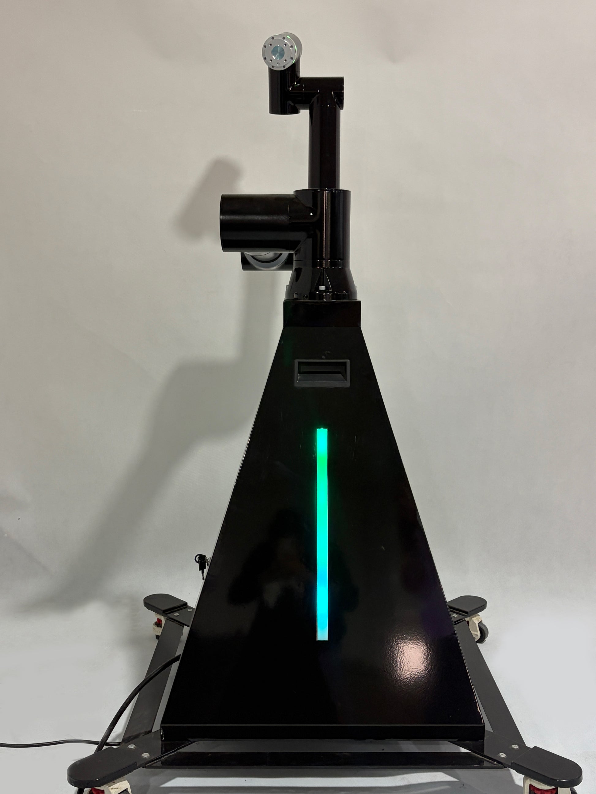 A black robotic arm photobooth with a colorful light stripe, designed for capturing images at events such as weddings and parties.