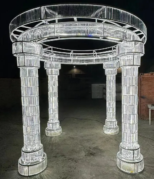 Large crystal archway structure lit in LED lighting indoors with a dark background