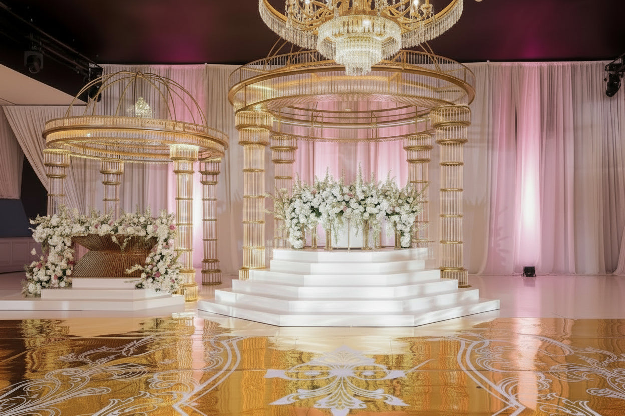 Set of 2 golden mandaps setup with floral arrangements and chandeliers in an elegant wedding setting