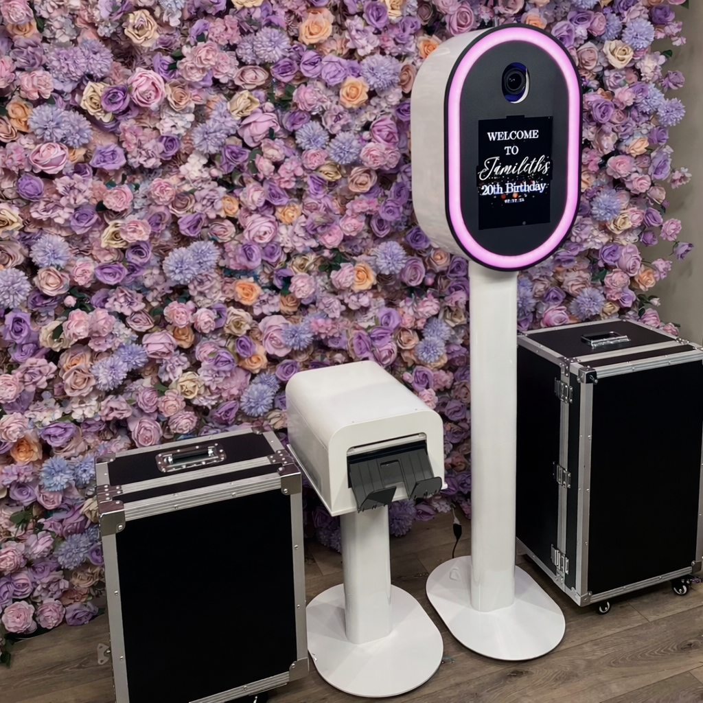 Metal DSLR iPad Selfie Pod Photobooth LED with printer stand setup against a floral wall background with 2 flight cases