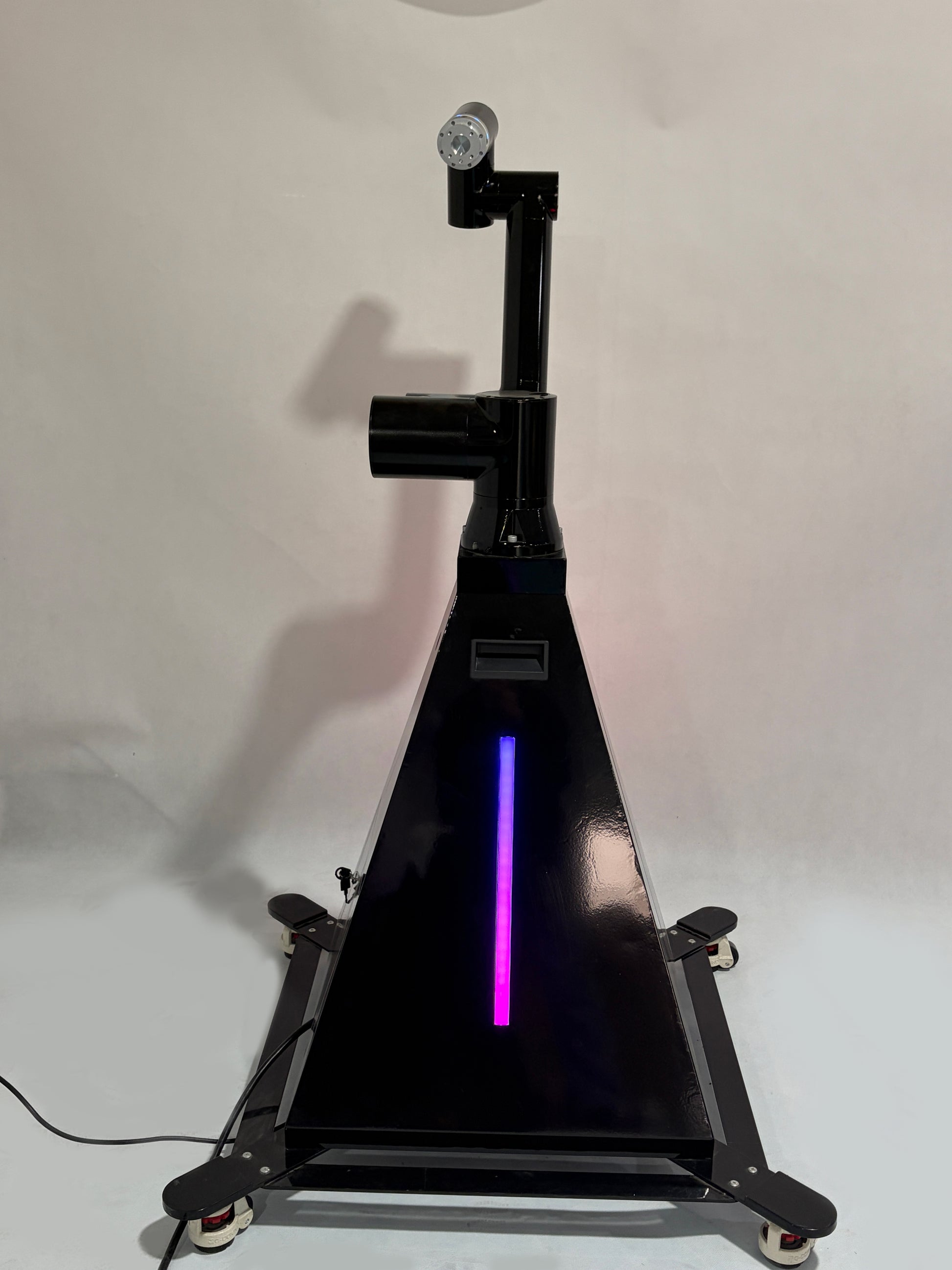 A black robotic arm photobooth with a colorful light stripe, designed for capturing images at events such as weddings and parties.