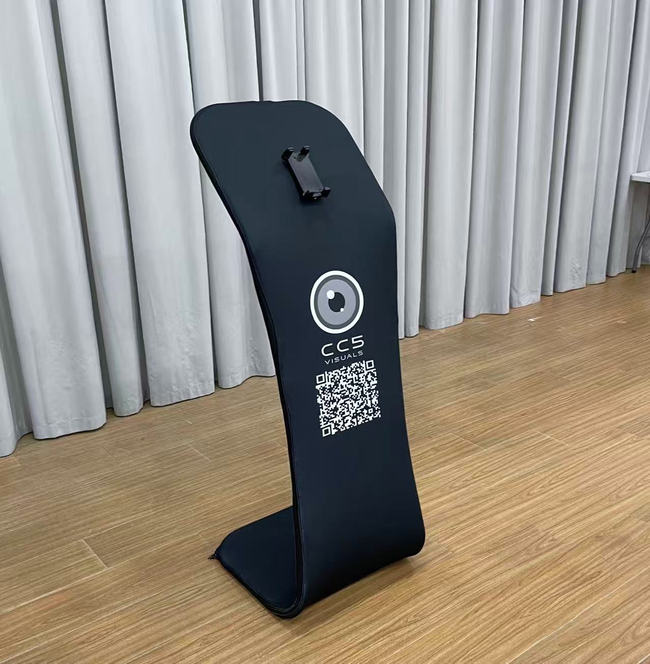 A black customisable tablet sharing station with CC5 Visuals logo on the side and a tablet mounted on top