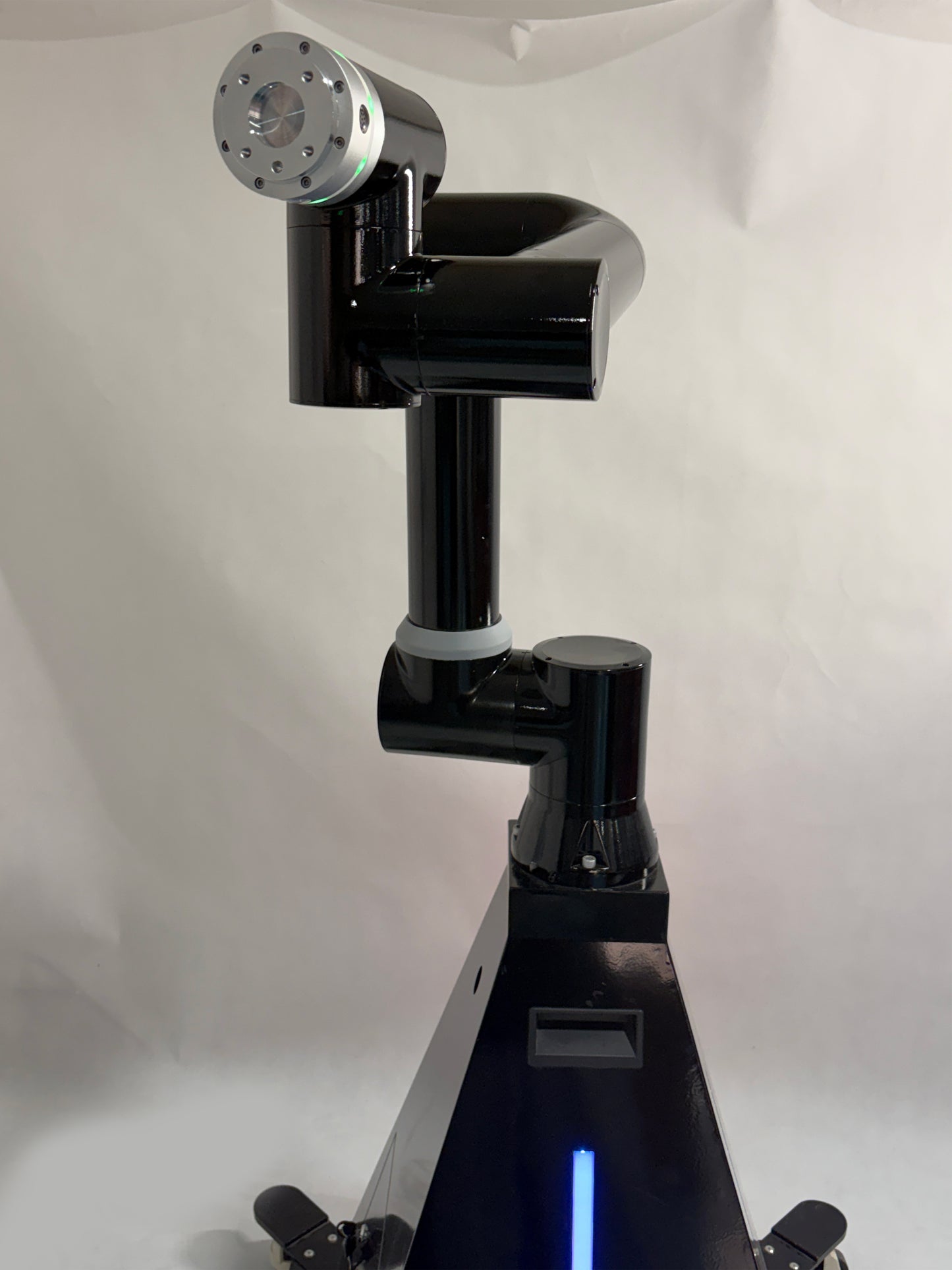 A black robotic arm photobooth with a colorful light stripe, designed for capturing images at events such as weddings and parties.