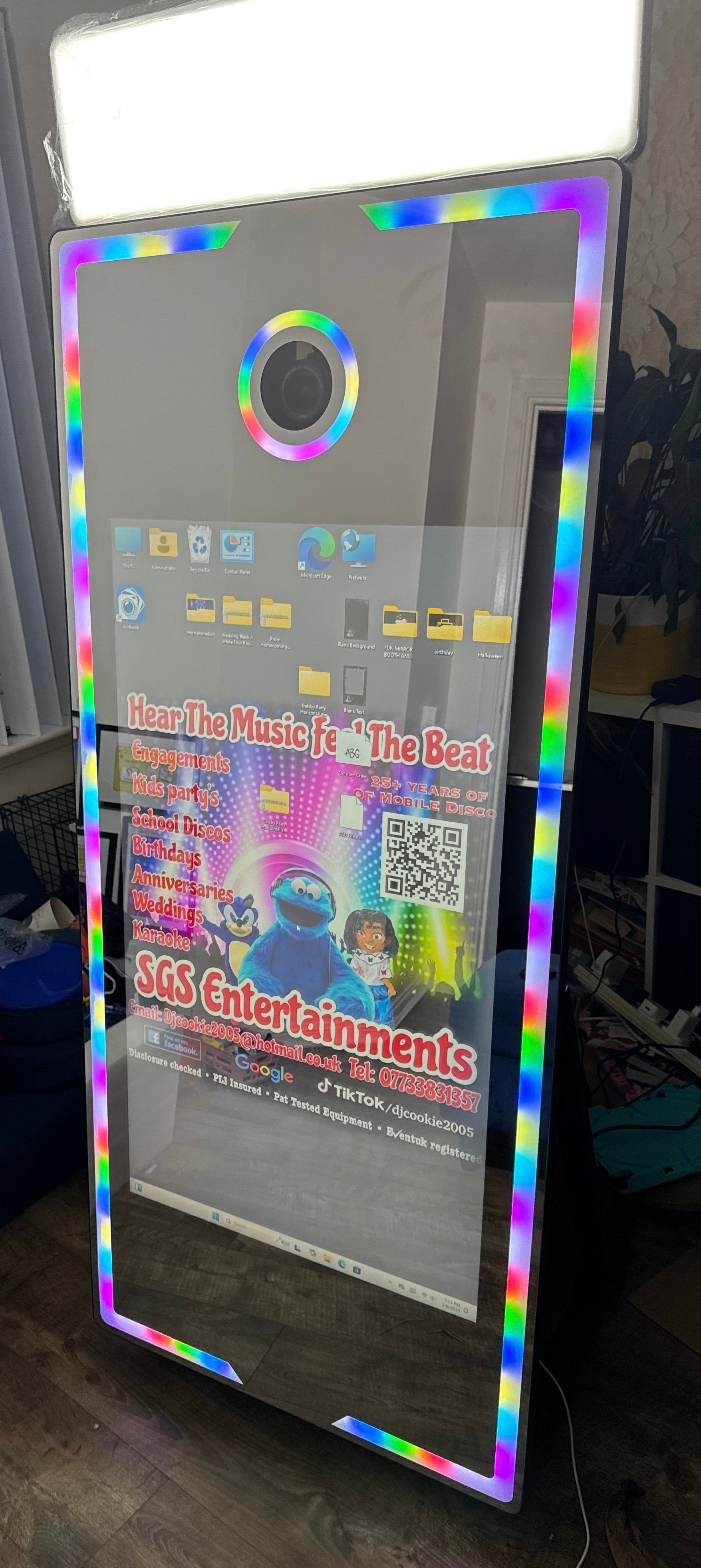 magic mirror photobooth with colorful frame showing event information and QR code.