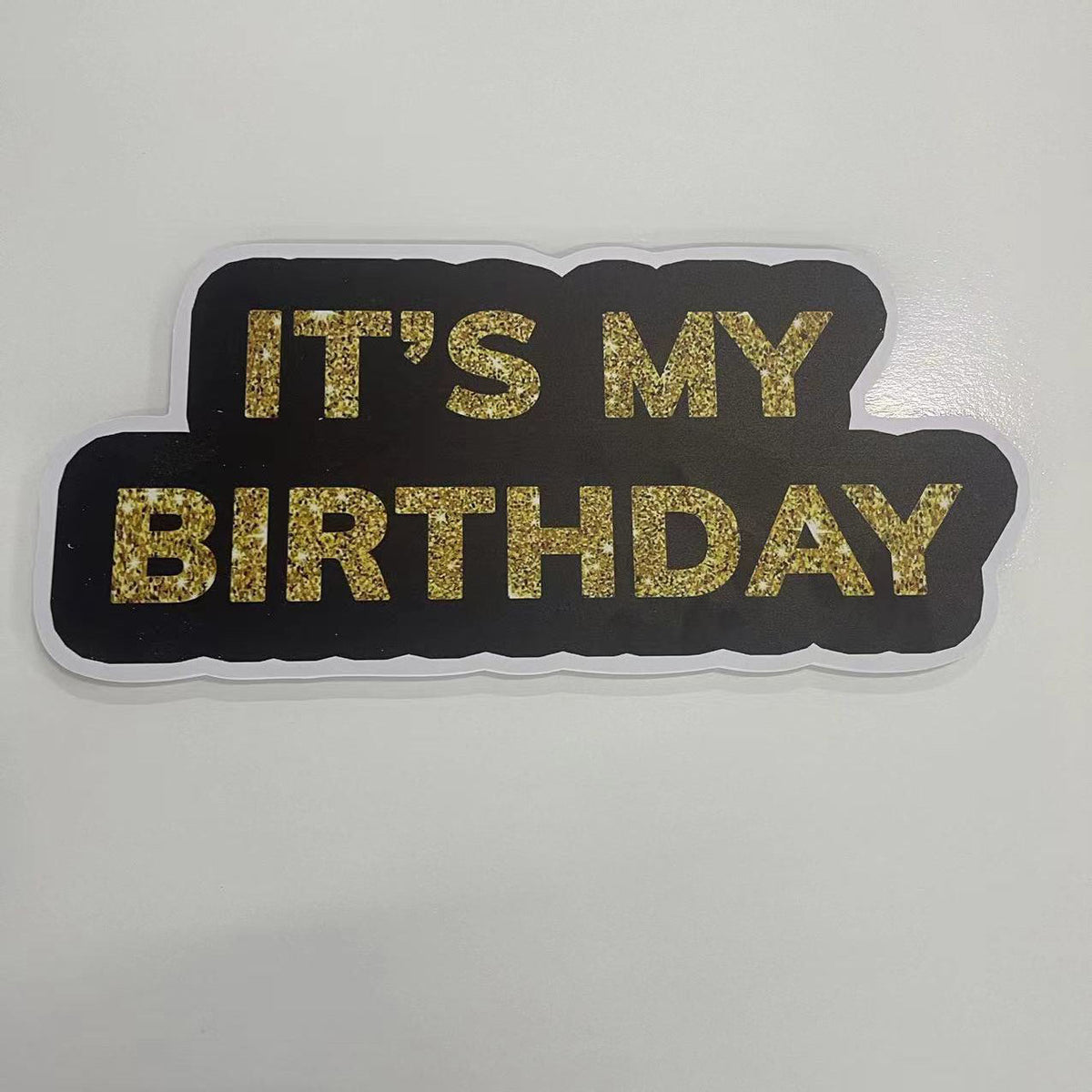 Black and gold 'It's My Birthday' photobooth prop on a white background