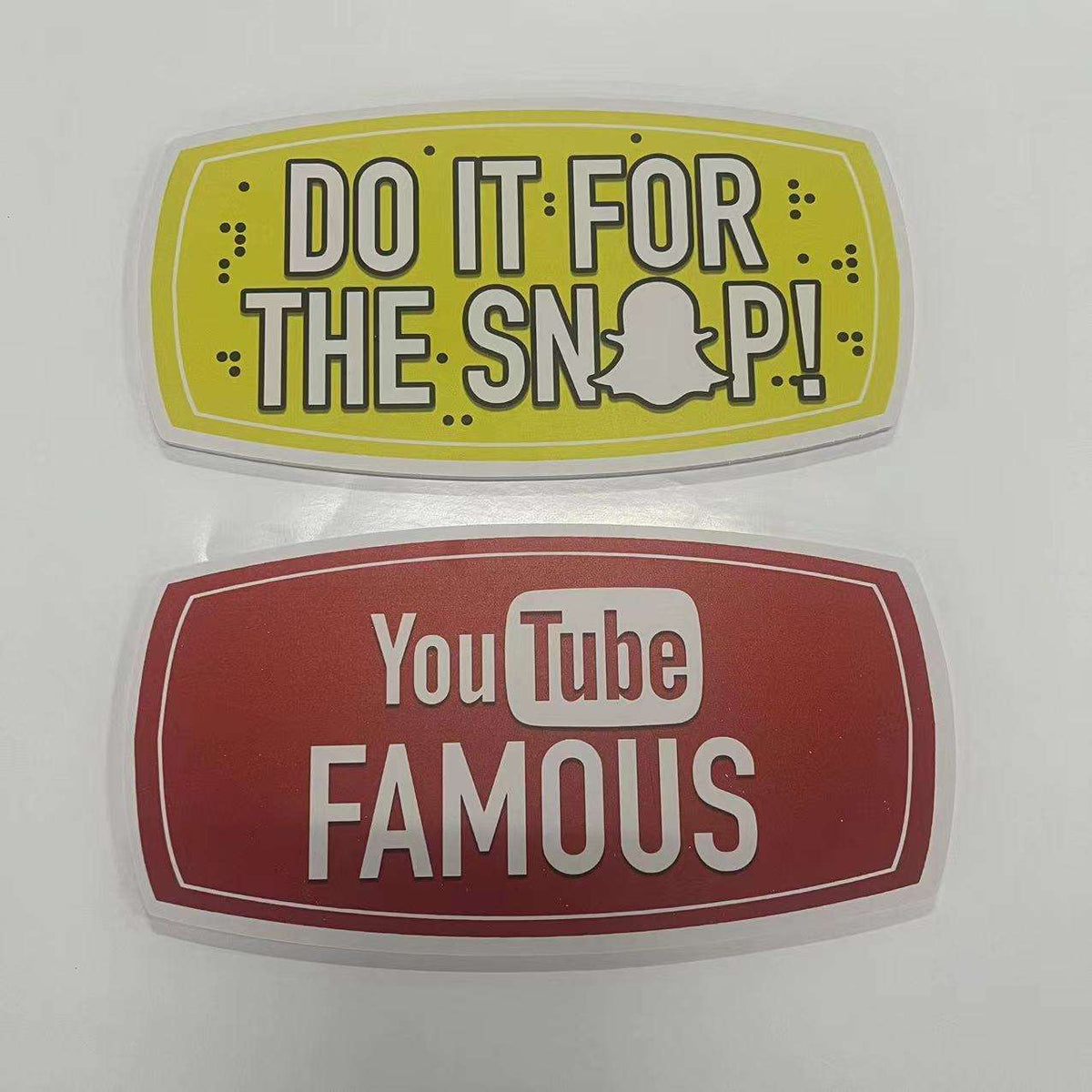 Two photobooth props with text and logos on a white background
