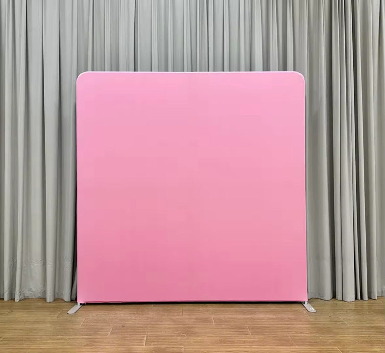 Pink display panel against a gray curtain background