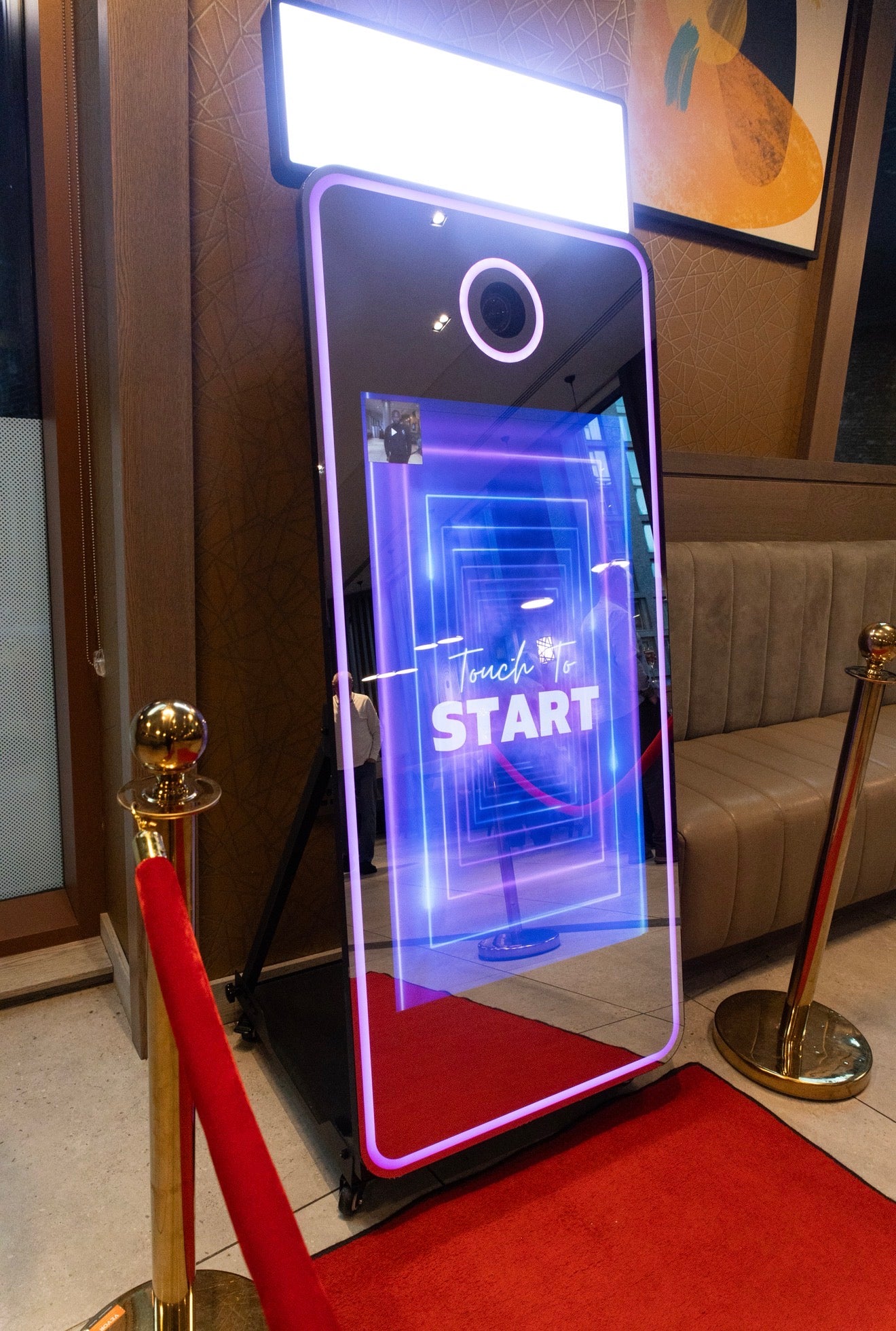 Interactive mirror with digital display on a red carpet