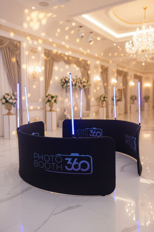 A 2-piece LED photobooth enclosure with blue LED lights and black cloth covering, designed for events and parties.