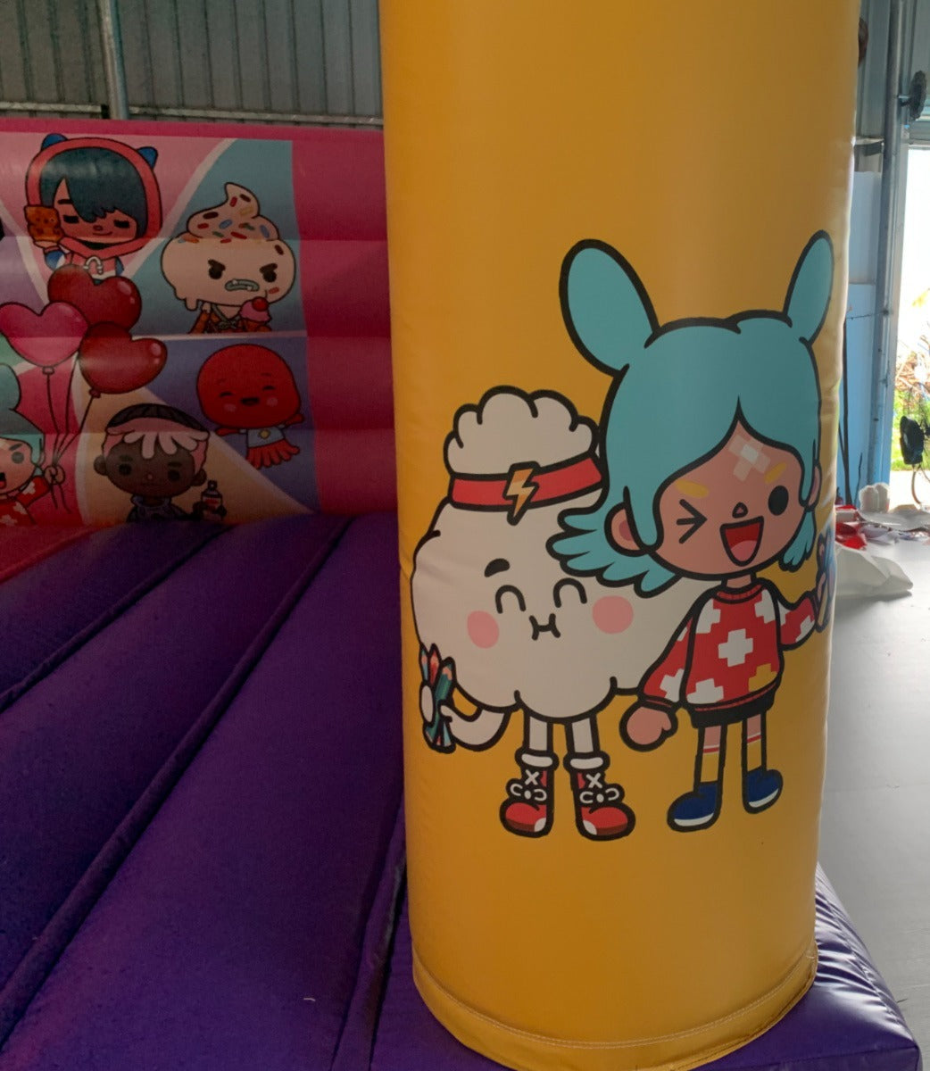 Yellow inflatable tube with cartoon characters on a bouncy castle background