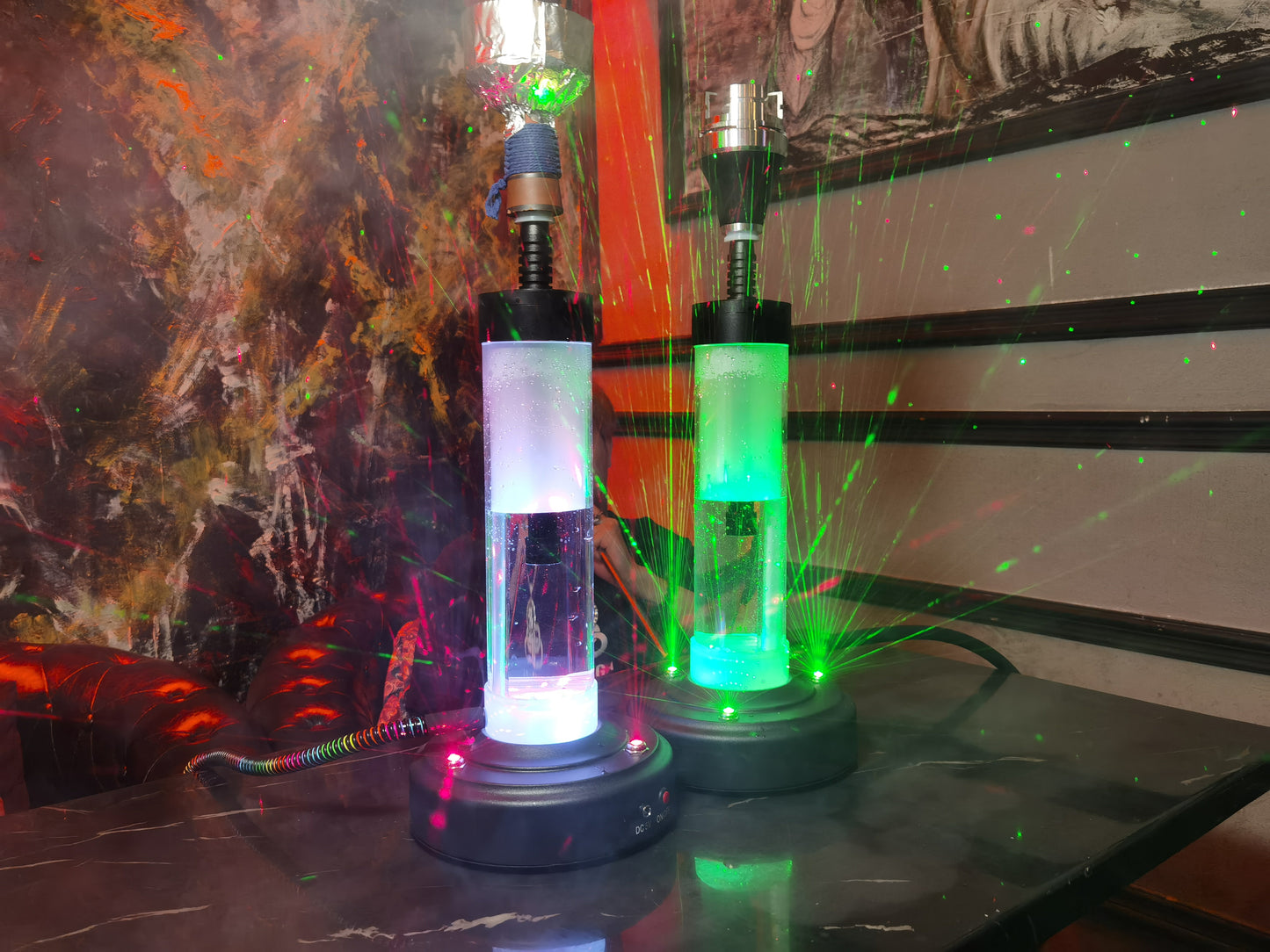 Two colourful electric shisha pipes in a club/restaurant setting.
