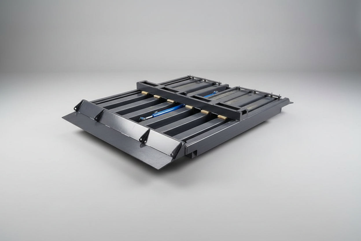 Metallic industrial component with a blue actuator on a grey floor