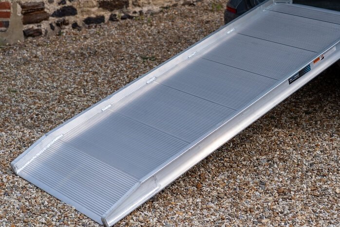 Sturdy, large aluminium ramp on a gravel surface
