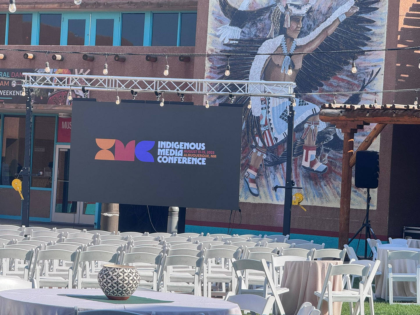 Outdoor Conference setup with large LED screen on display rigged to stands and lights 