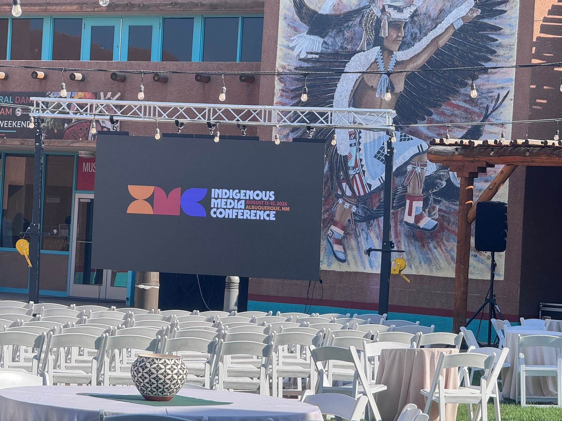 Outdoor Conference setup with large LED screen on display rigged to stands and lights 