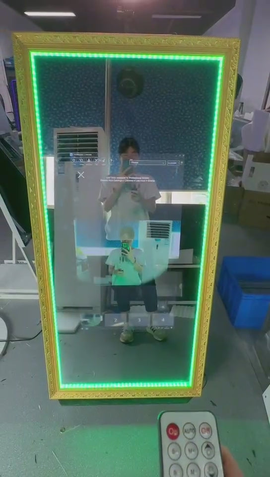 Interactive touch screen magic mirror photobooth with a vintage-style frame and colourful LED lights at the top.