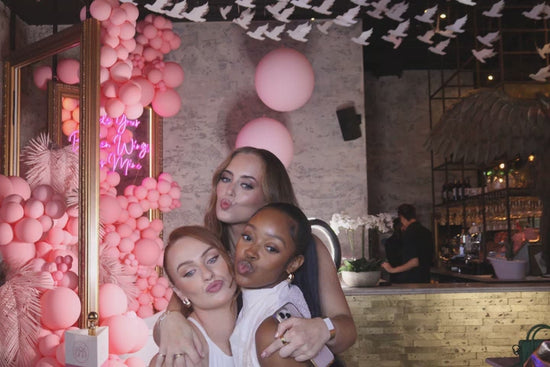 A white roaming robot photobooth with a DSLR camera mounted on a stand, featuring a screen for iPad control interface.