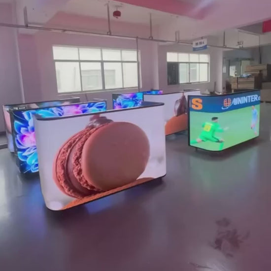 Various DJ booths with LED screens displaying video games, cartoons and other visuals
