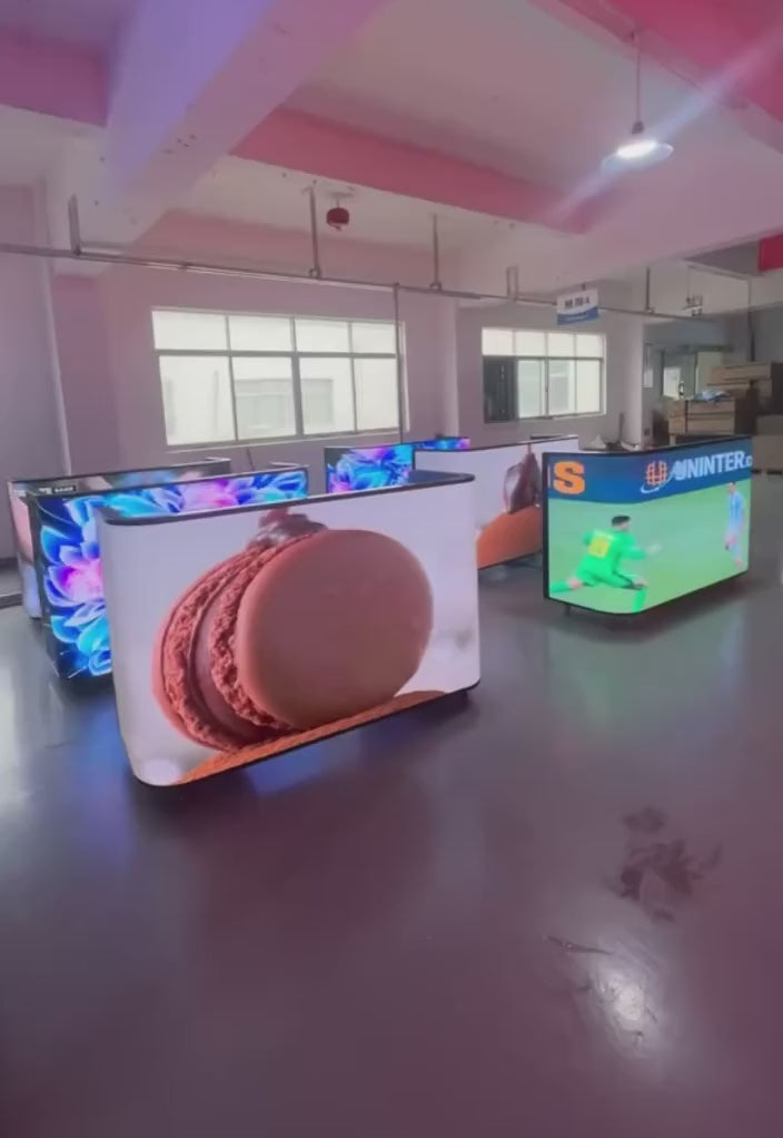 Various DJ booths with LED screens displaying video games, cartoons and other visuals