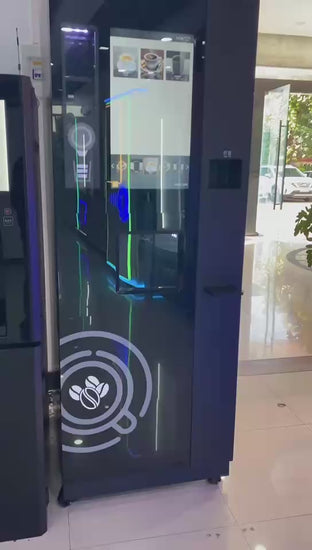 Lady using coffee vending machine with options for latte, cappuccino and tea.