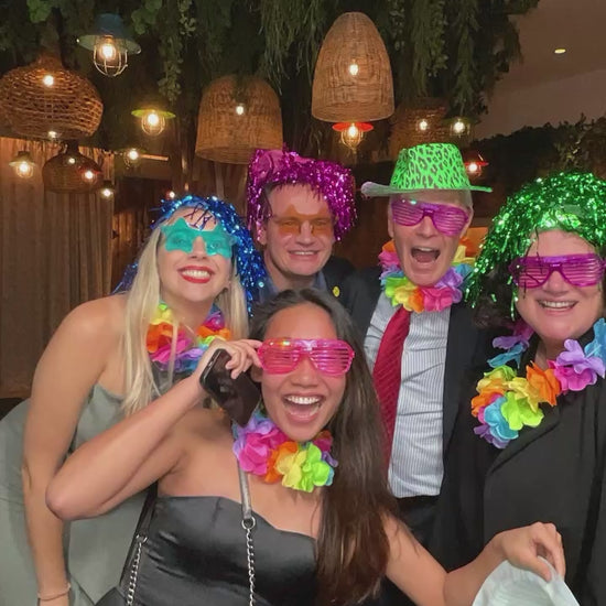 Group of corporate clients laughing and smiling using magic mirror photobooth