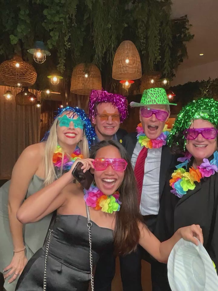 Group of corporate clients laughing and smiling using magic mirror photobooth