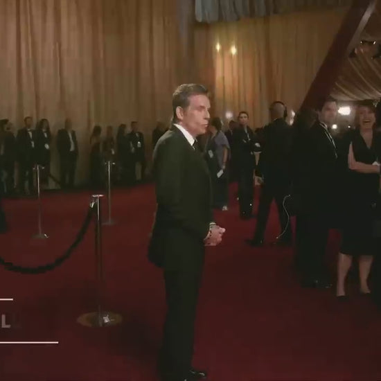 A black robotic arm photobooth with a colorful light stripe, designed for capturing images at events such as weddings and parties.