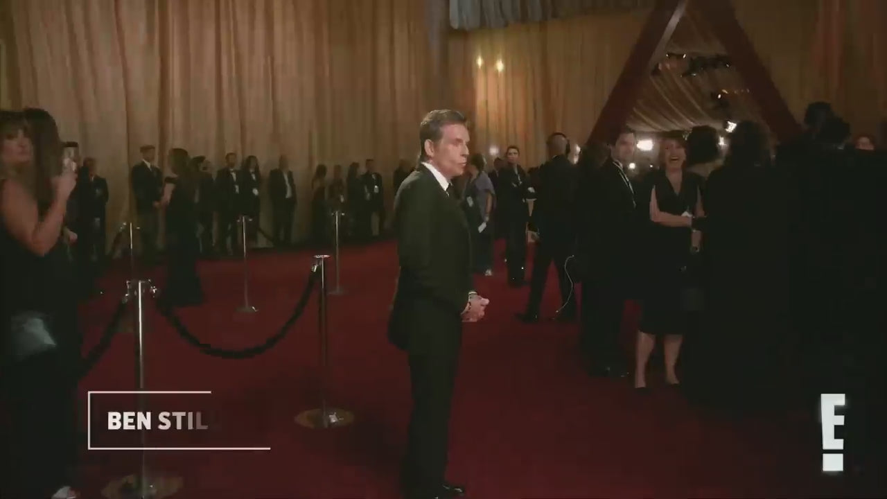 A black robotic arm photobooth with a colorful light stripe, designed for capturing images at events such as weddings and parties.