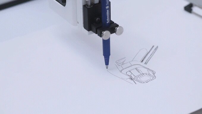 3D printer in action, creating a design on a white surface