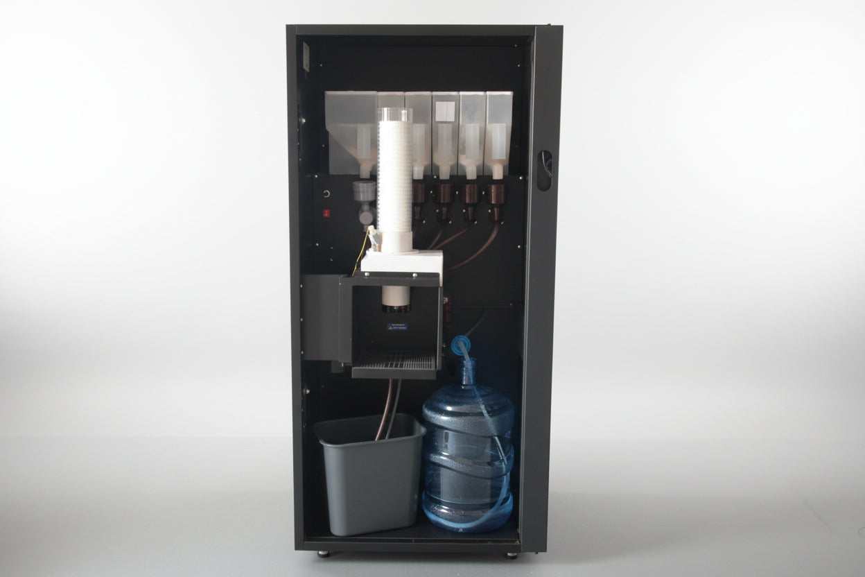 Interior of the coffee ending machine, showing water dispenser and flavoured powwders.